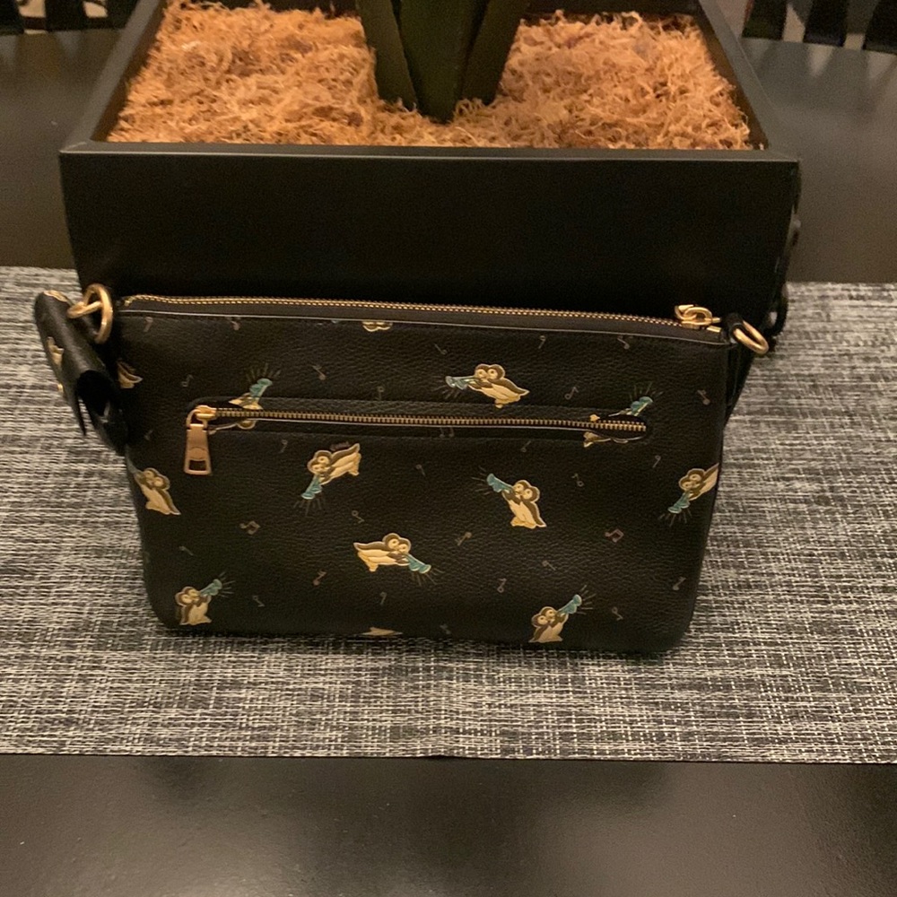 Coach leather penguin trumpet bag with iPod case Missing hanging tag and strap